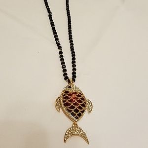 Long necklace with fish pendant